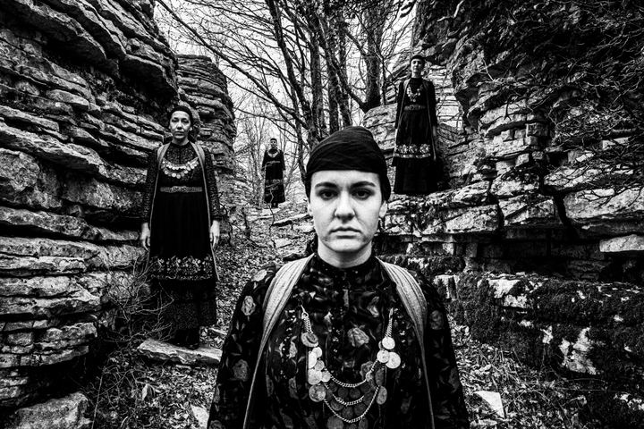 Four women wearing the local dresses of Zagori, Epirus, at the stone forest in Monodendri