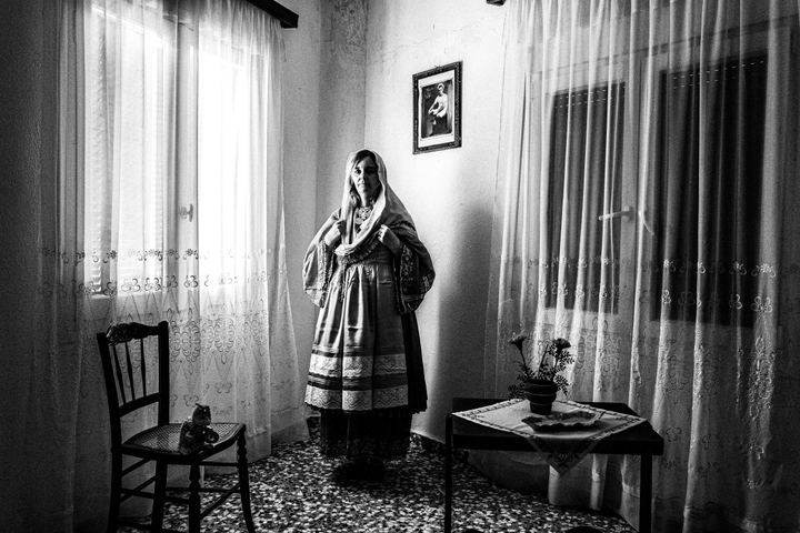 Woman wearing the local costume of Trikeri, Magnesia, inside a local house