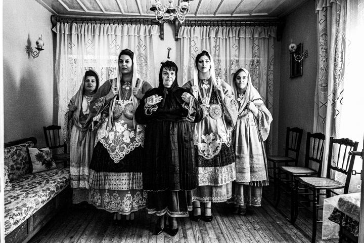Women wearing the local dressed of Trikeri in Magnesia, inside a traditional local house.