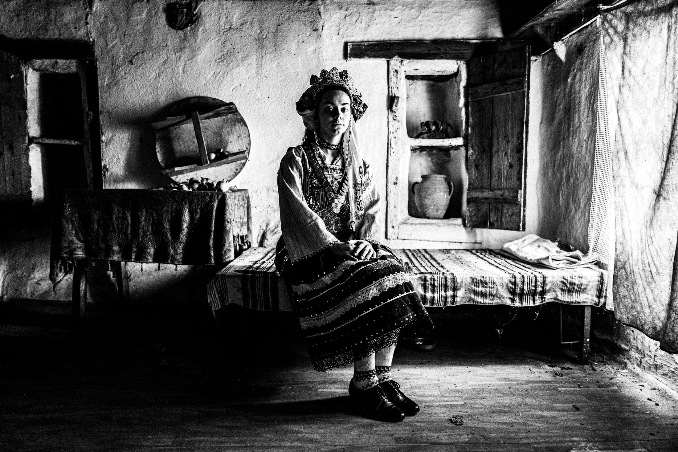 Woman wearing the local Metaxades costume, posing inside a local house in Paliouri, Evros, Thrace