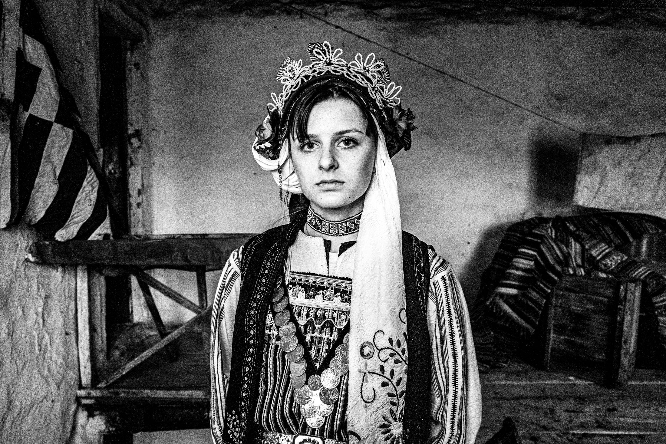 Woman wearing the local Metaxades costume, posing inside a local house in Paliouri, Evros, Thrace