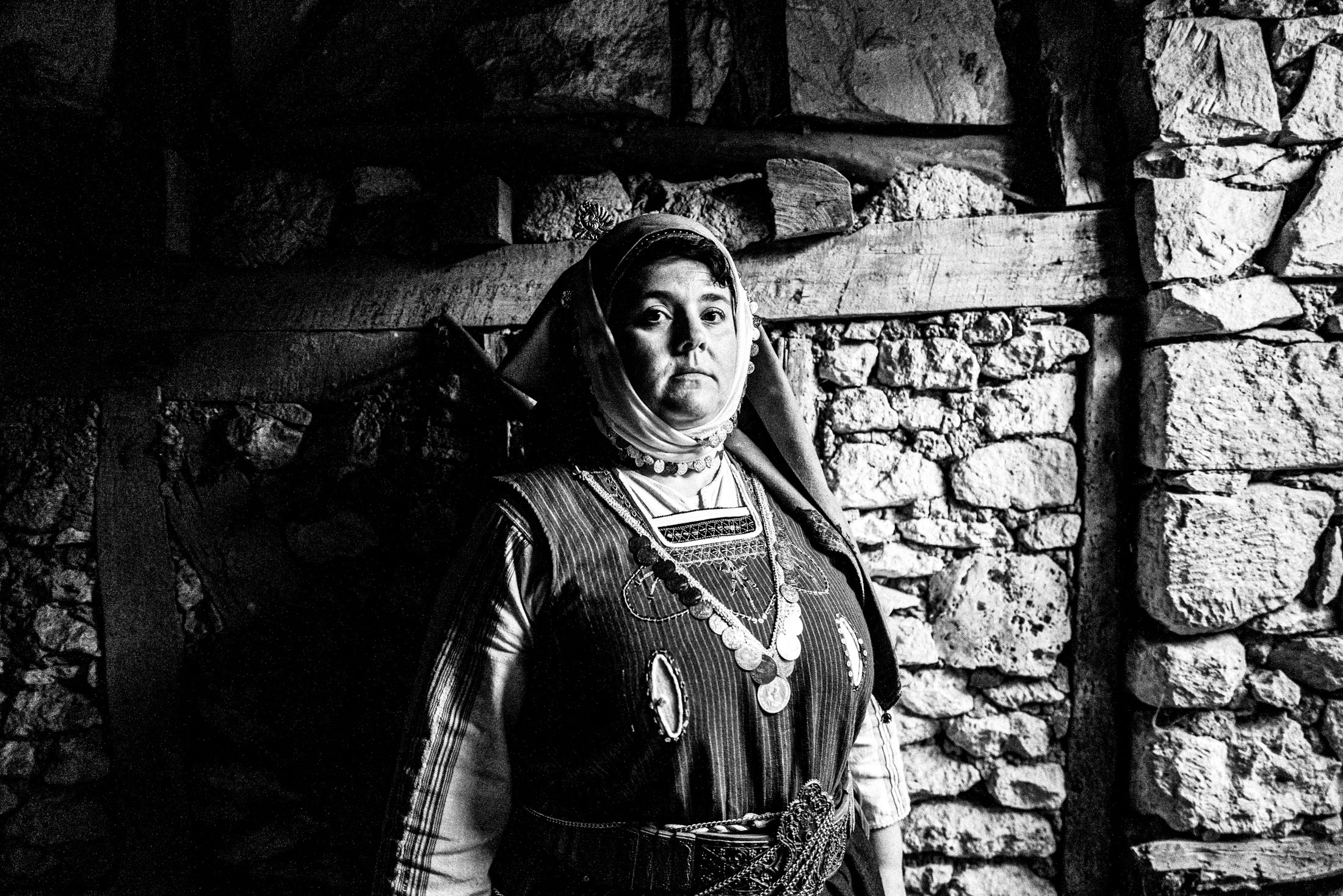 Woman wearing the local Metaxades costume, posing inside a local house in Paliouri, Evros, Thrace