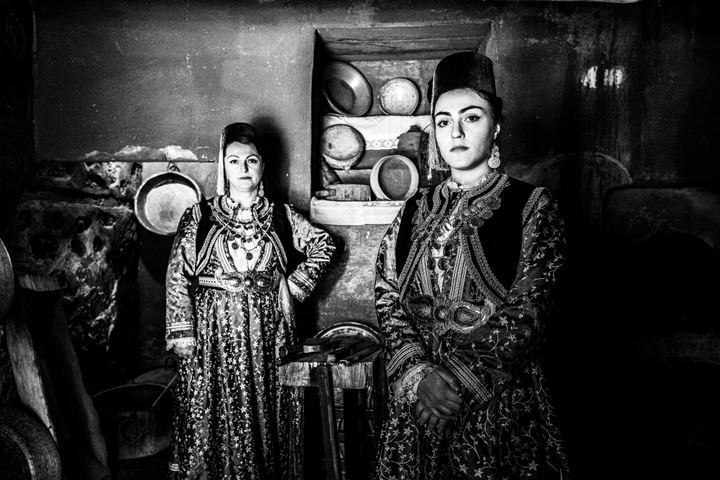 Women wearing the local costumes of Kastoria inside a local traditional mansion