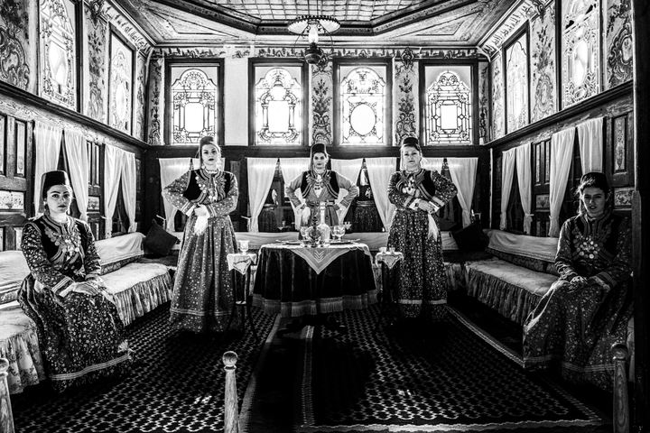 Women wearing the local costumes of Kastoria inside a local traditional mansion