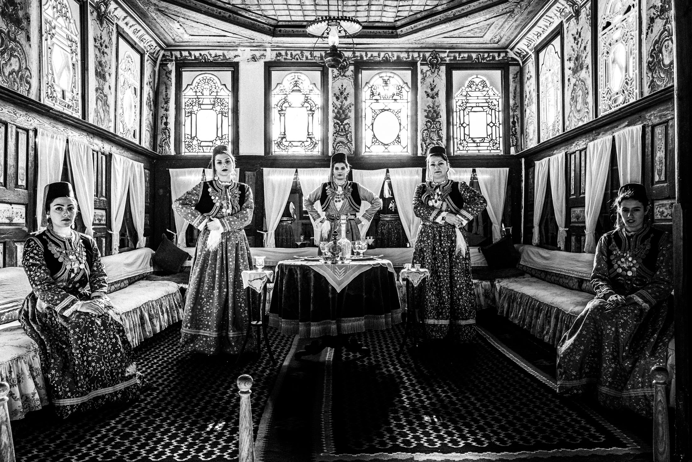 Women wearing the local costumes of Kastoria inside a local traditional mansion