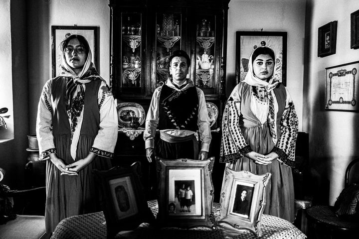 A man and two women wearing the costumes of Nisyros, inside a local house