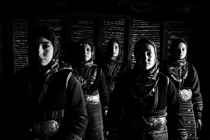 Women wearing the local costumes of Orini in Serres, inside a local old house