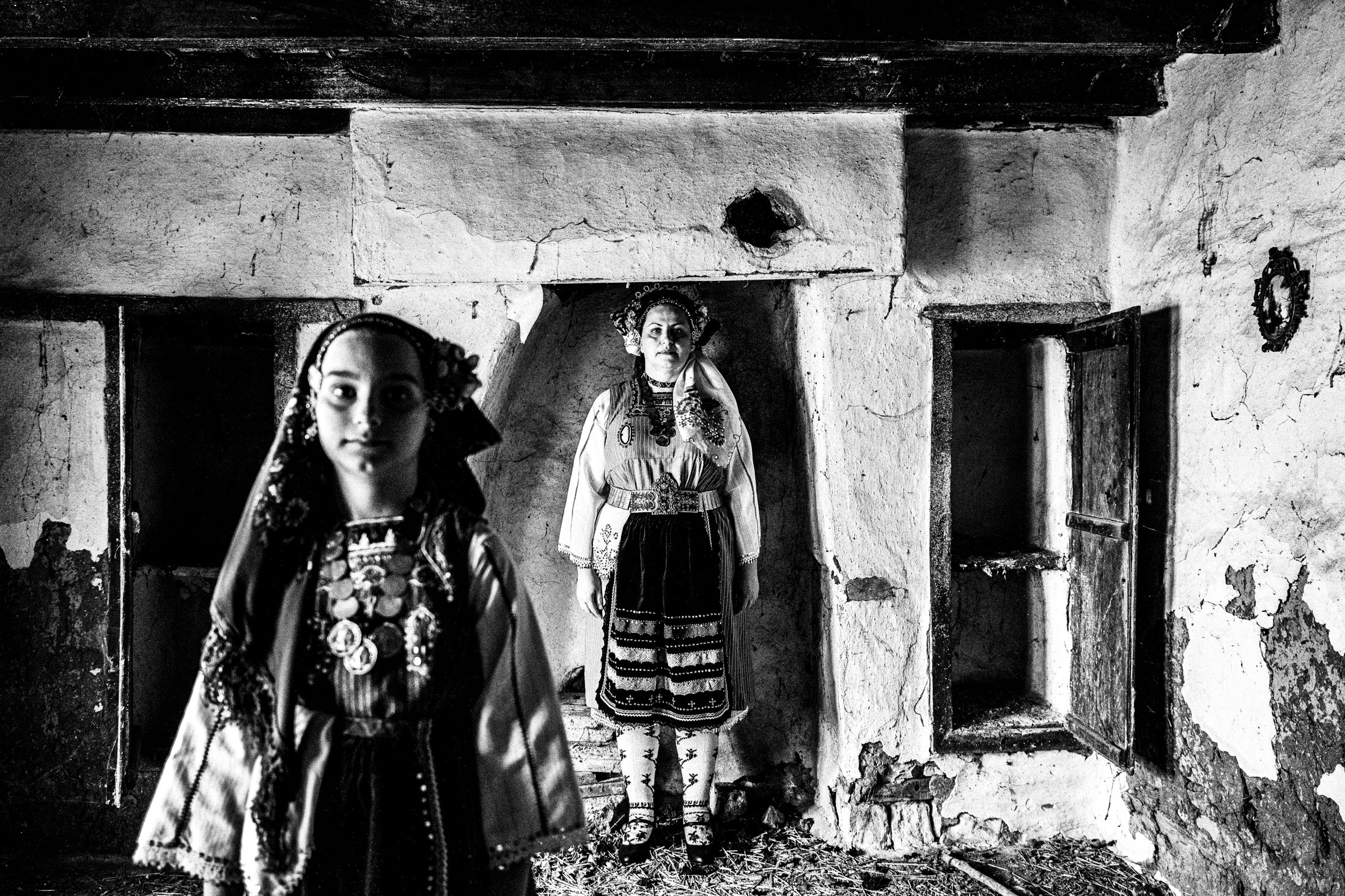 Mother and daughter wearing the local costume of Metaxades, inside a local house. Evros, Thrace