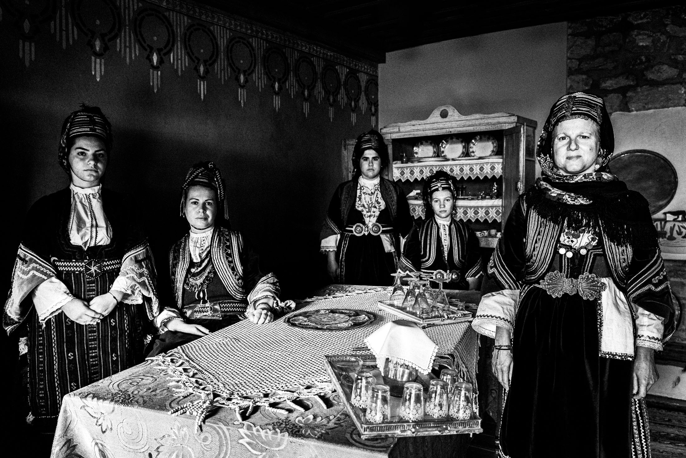 A group of women wearing the local costumes of Prosotsani, Drama posing inside a local house