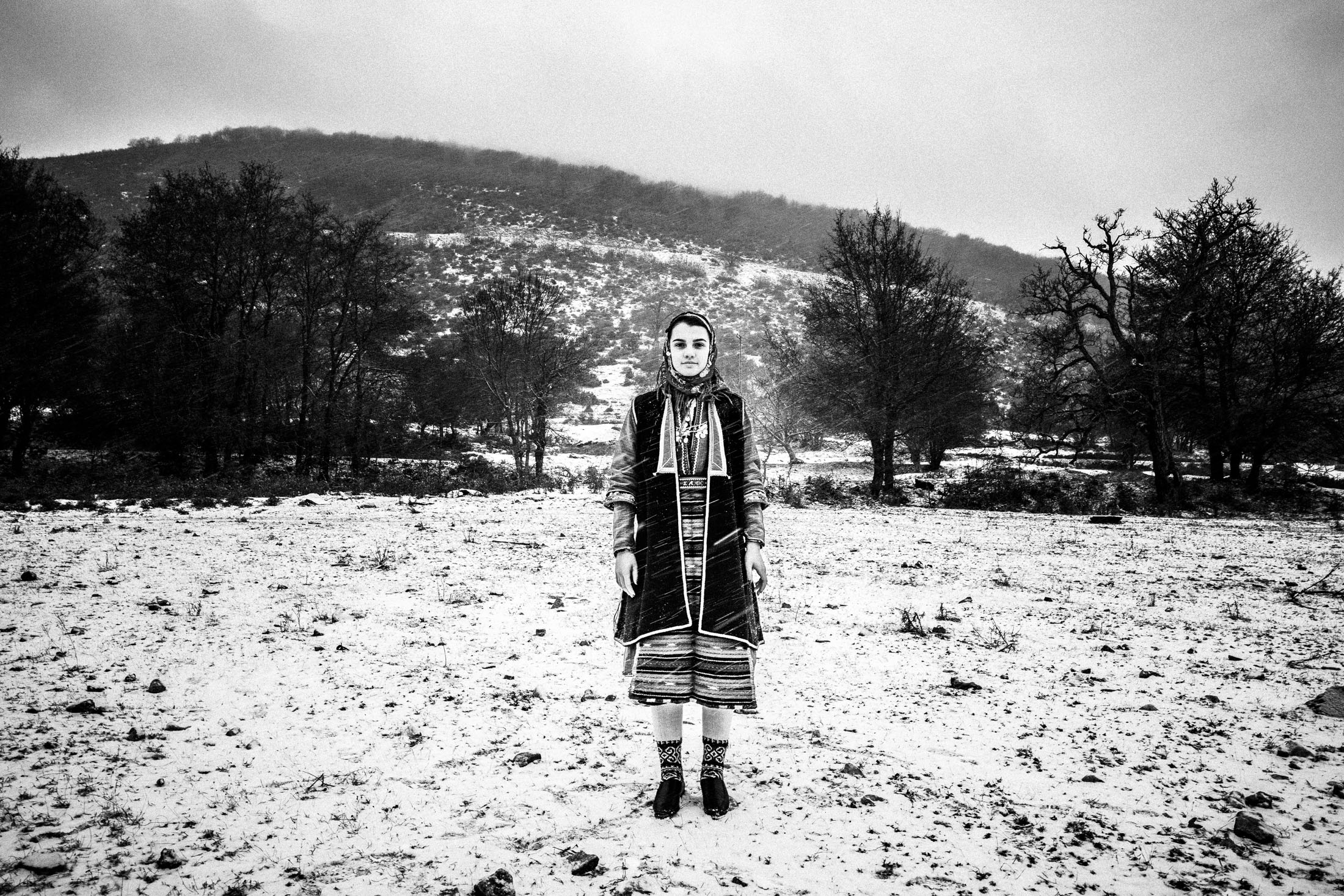 A young woman wearing the local costume of Volakas, Drama, posing in the snow.