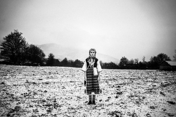A young woman wearing the local costume of Volakas, Drama, posing in the snow.