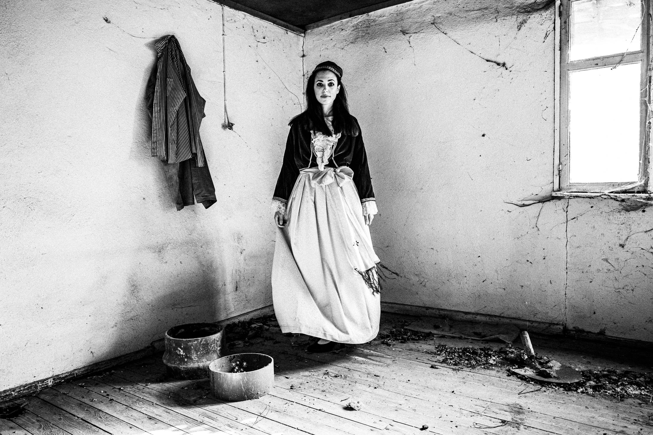 Woman wearing the urban dress of Pelion, inside a house in Portaria