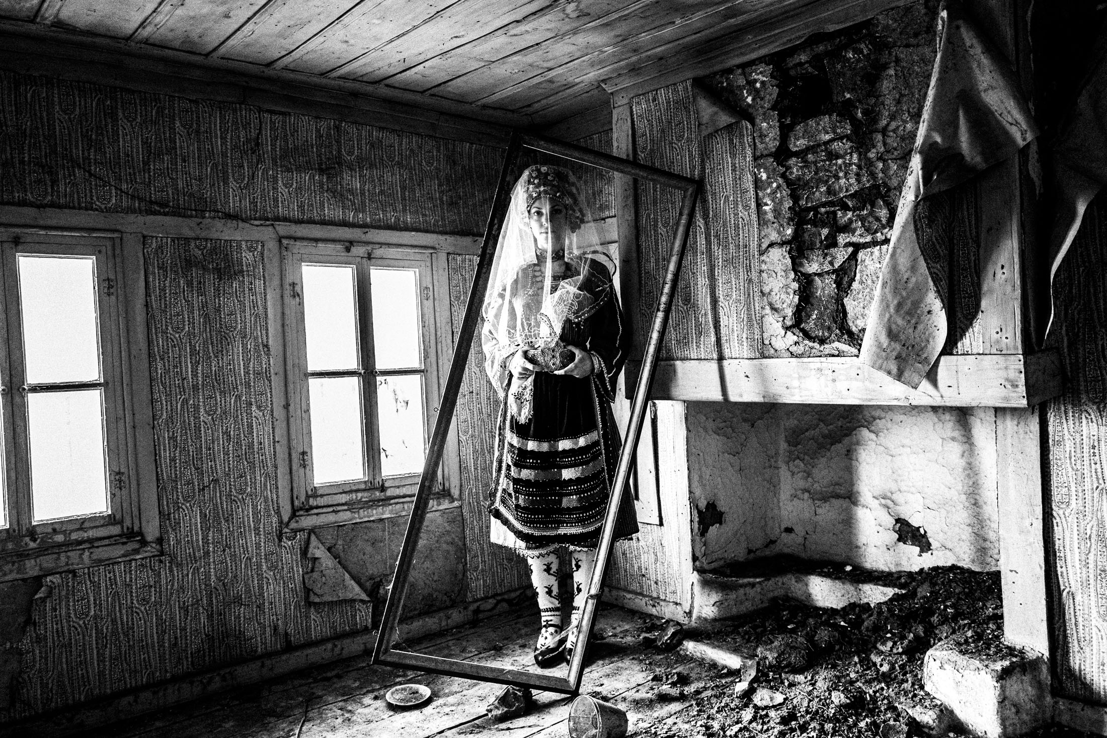 A veiled woman wearing the local bridal dress of Metaxades, inside a local house. Evros, Thrace