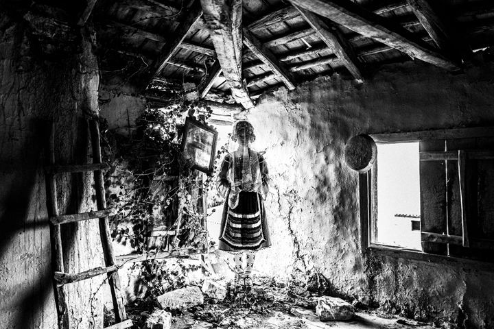 A veiled woman wearing the local bridal dress inside a ruined local house in Metaxades.