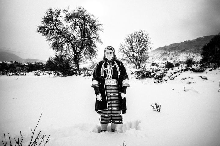 A young woman wearing the local costume of Volakas, Drama, posing in the snow.