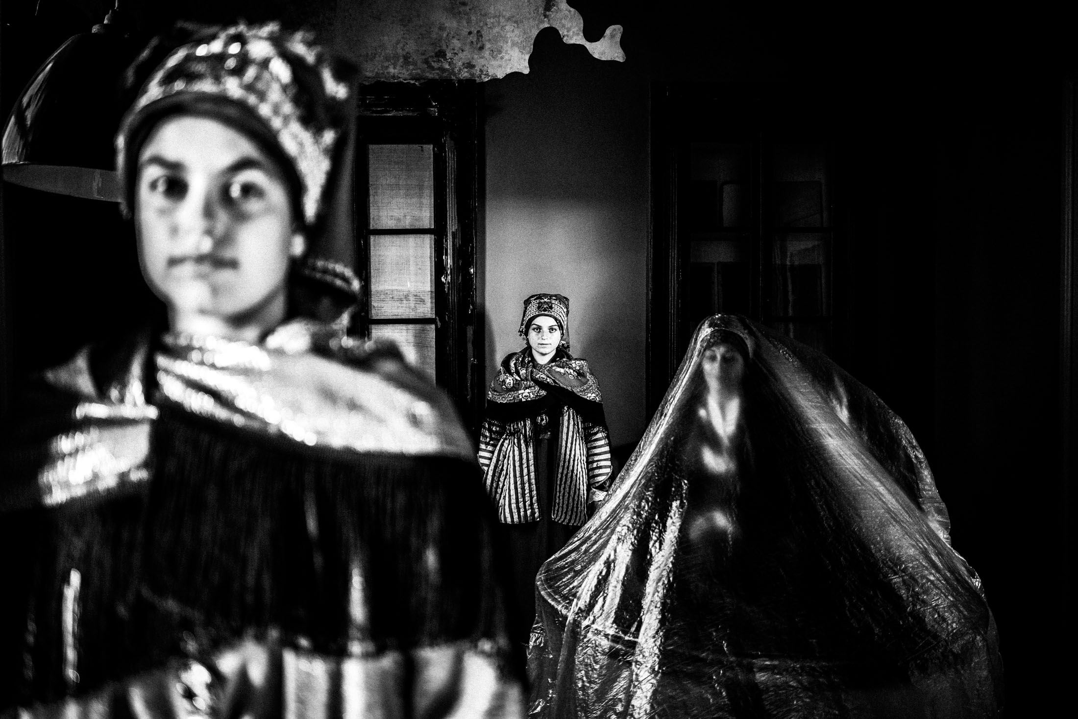 Women wearing the local costumes of Symi, inside a local house of the island