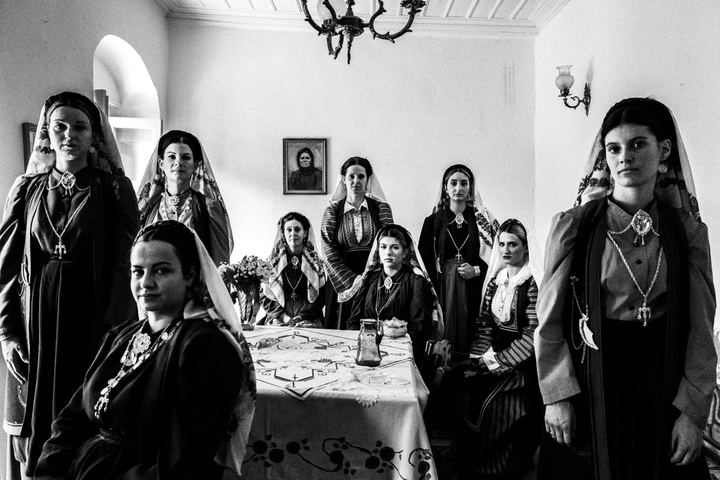 Women wearing the local dresses of Platanos, Nafpaktia, inside a local house