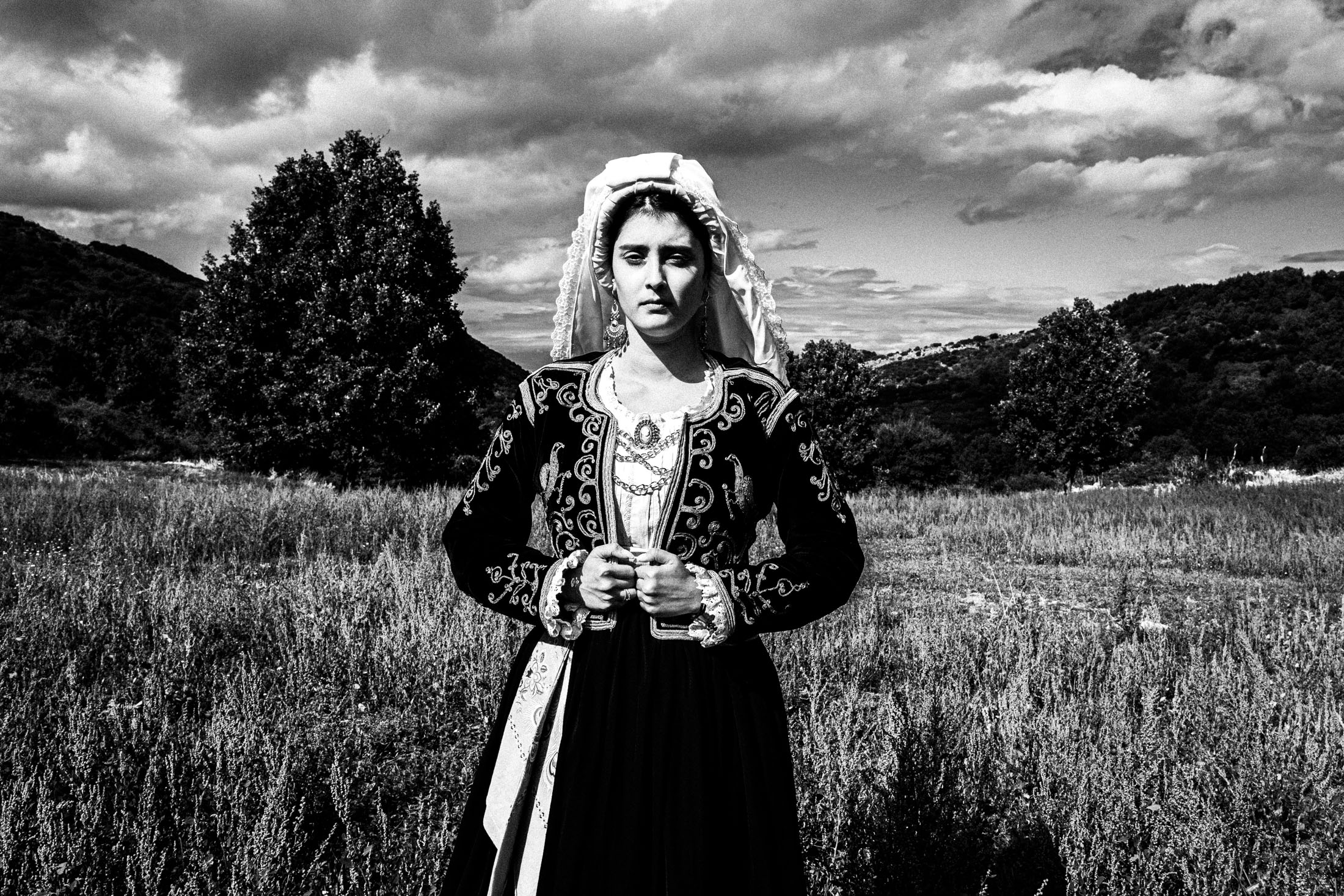 A woman in the costume of Northern Corfu posing at a local field