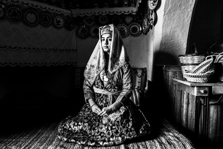 A woman wearing an authentic costume of Archangelos, Rhodes, inside the local folklore museum