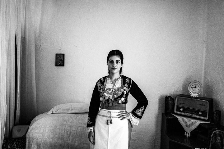 Zacharenia wearing traditional Sartza inside a local house.