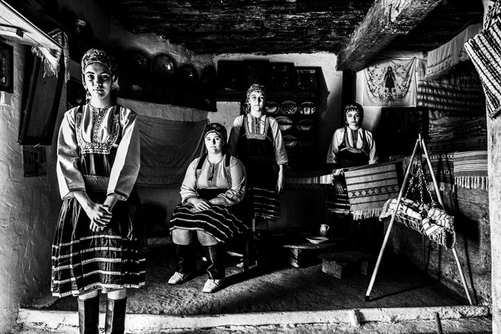 Four young girls wearing the local costume of Emponas, inside the local folklore museum