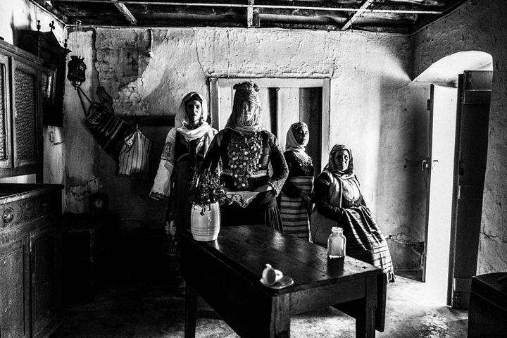 A group of women wearing the costumes of Megara, Attica, inside an old local house