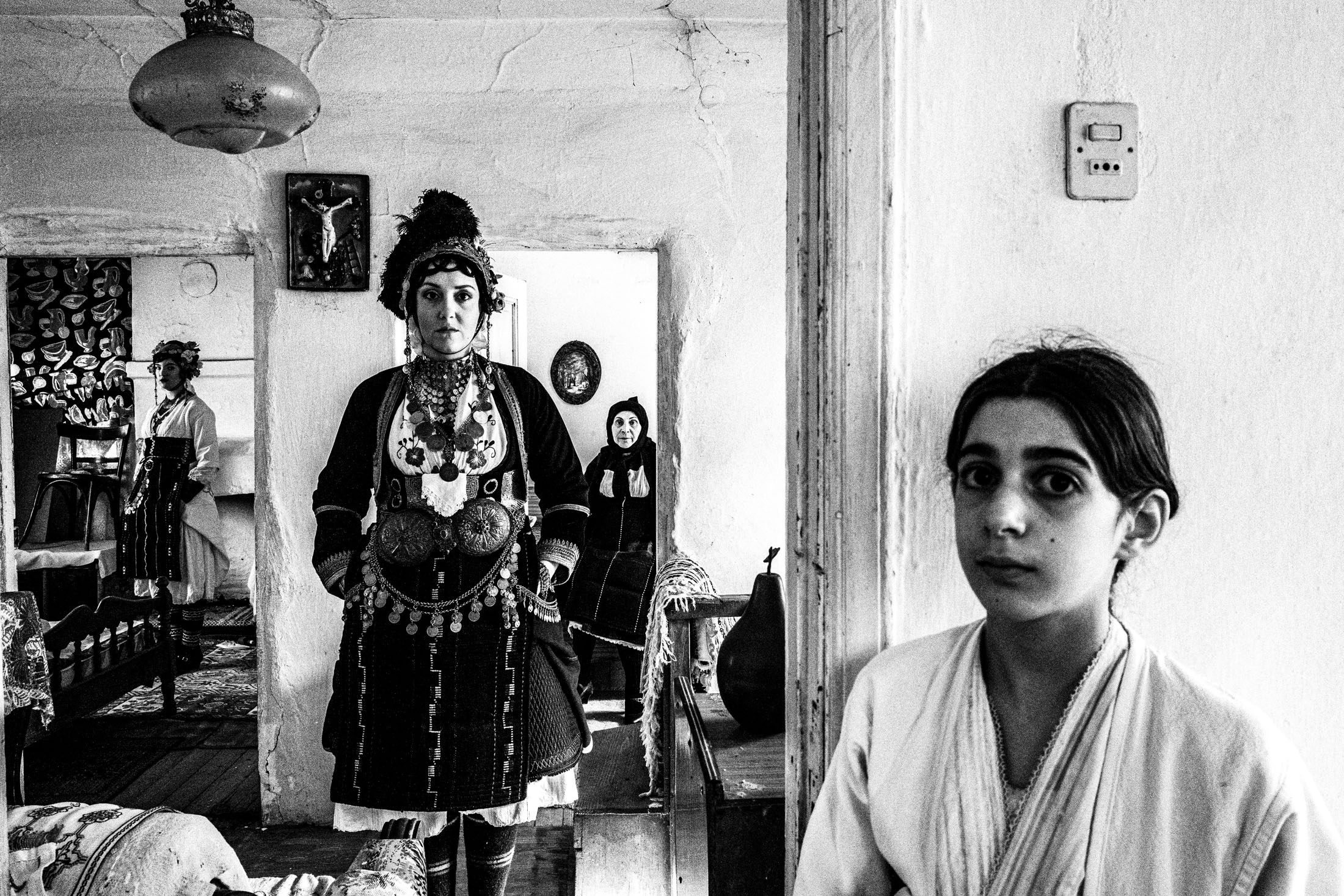 Women of different ages, wearing the local Roumlouki dresses of Meliki, Imathia, Macedonia, posing inside a local hosue