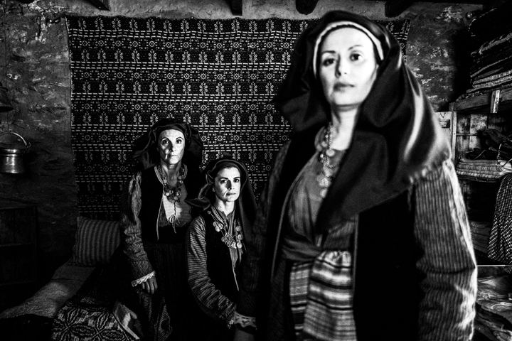 Three women, wearing the local dresses of Alagonia, photographed inside Nikitaras house in Nedoussa