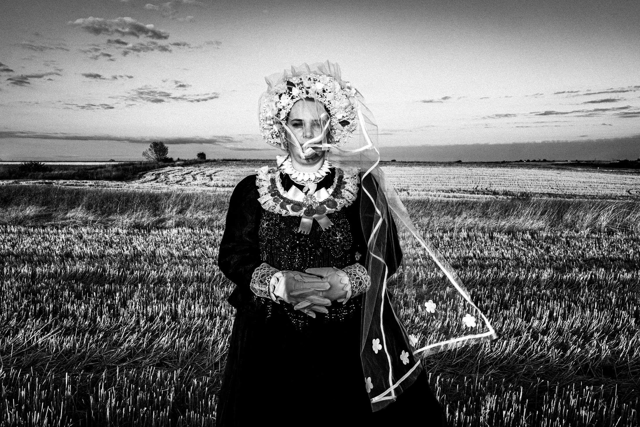 Woman wearing the local costume of Nea Vyssa, at a local field. Evros, Thrace, Greece
