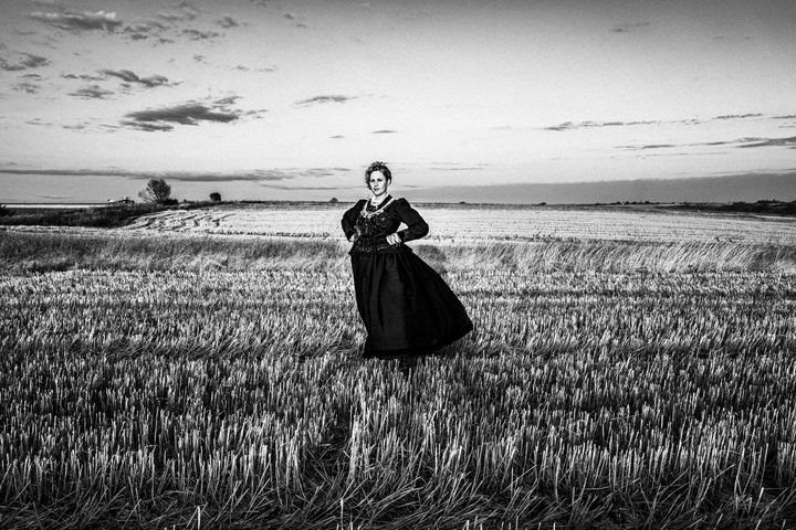 Woman wearing the local costume of Nea Vyssa, at a local field. Evros, Thrace, Greece