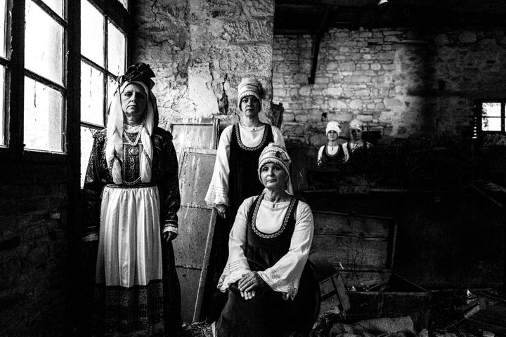 Women wearing the local costumes of Neochori, inside a local building