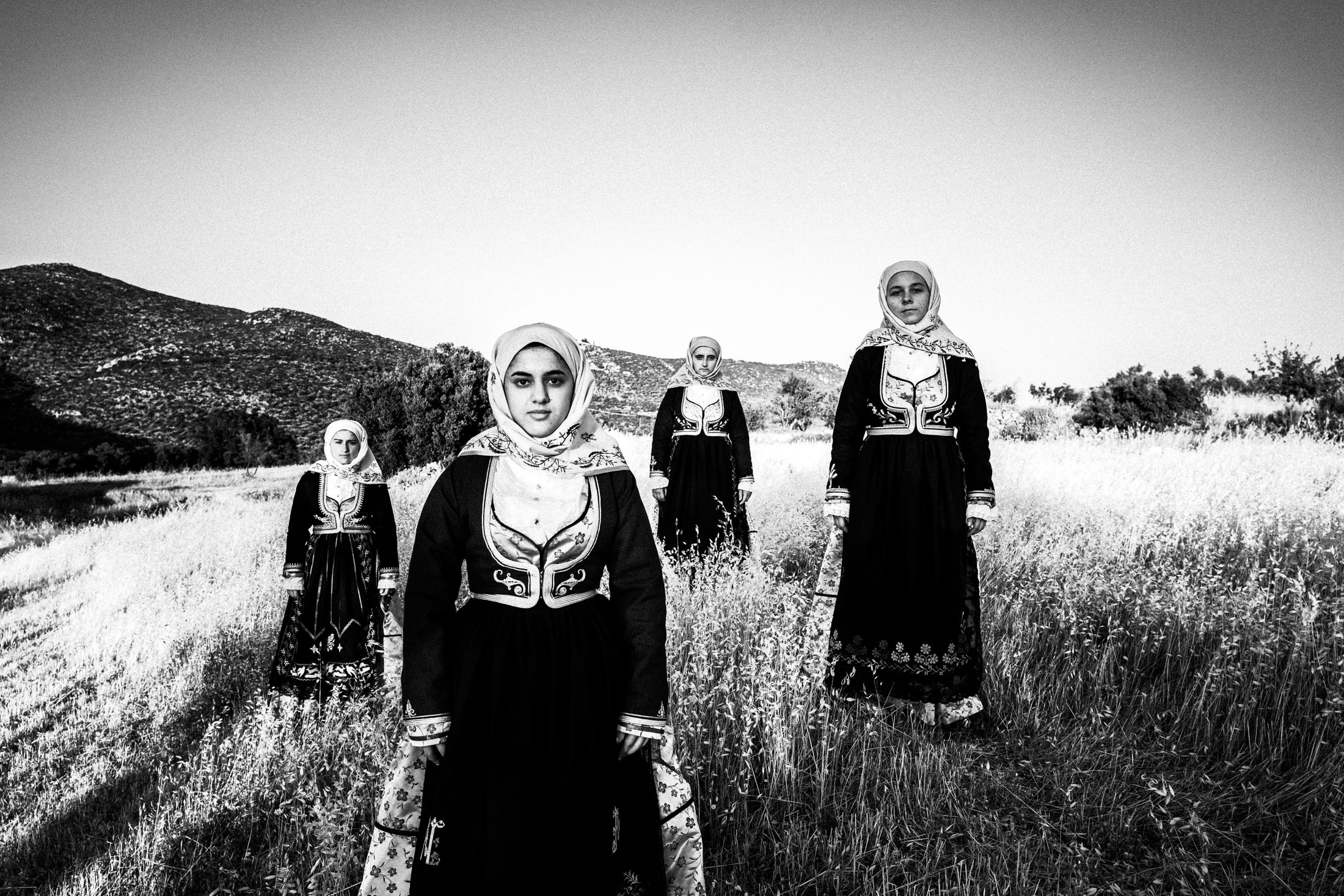 Four women wearing the traditional costumes of Geraki, Laconia, at a local field.