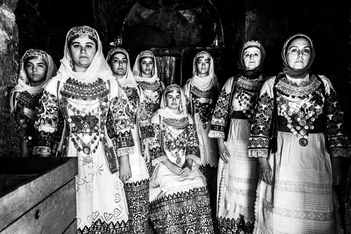 Women wearing the local costumes of Markopoulo in Attica, inside a local orthodox church