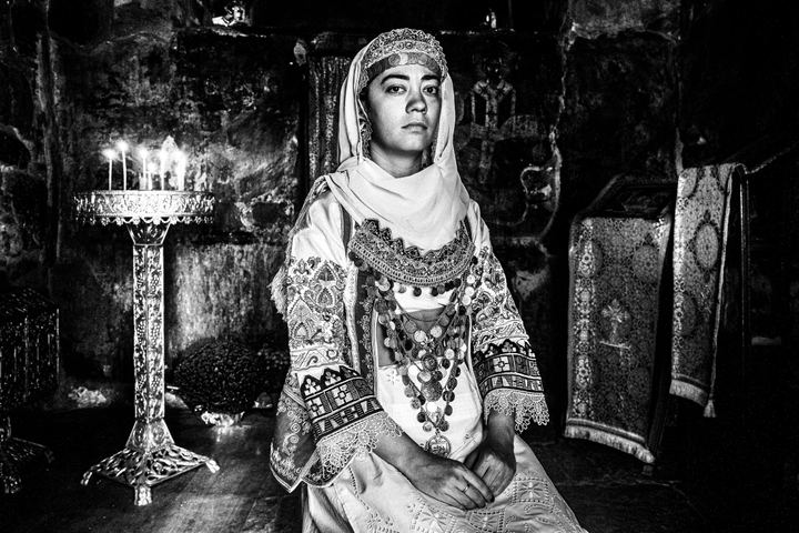 Woman wearing the local costume of Markopoulo in Attica, inside a local orthodox church
