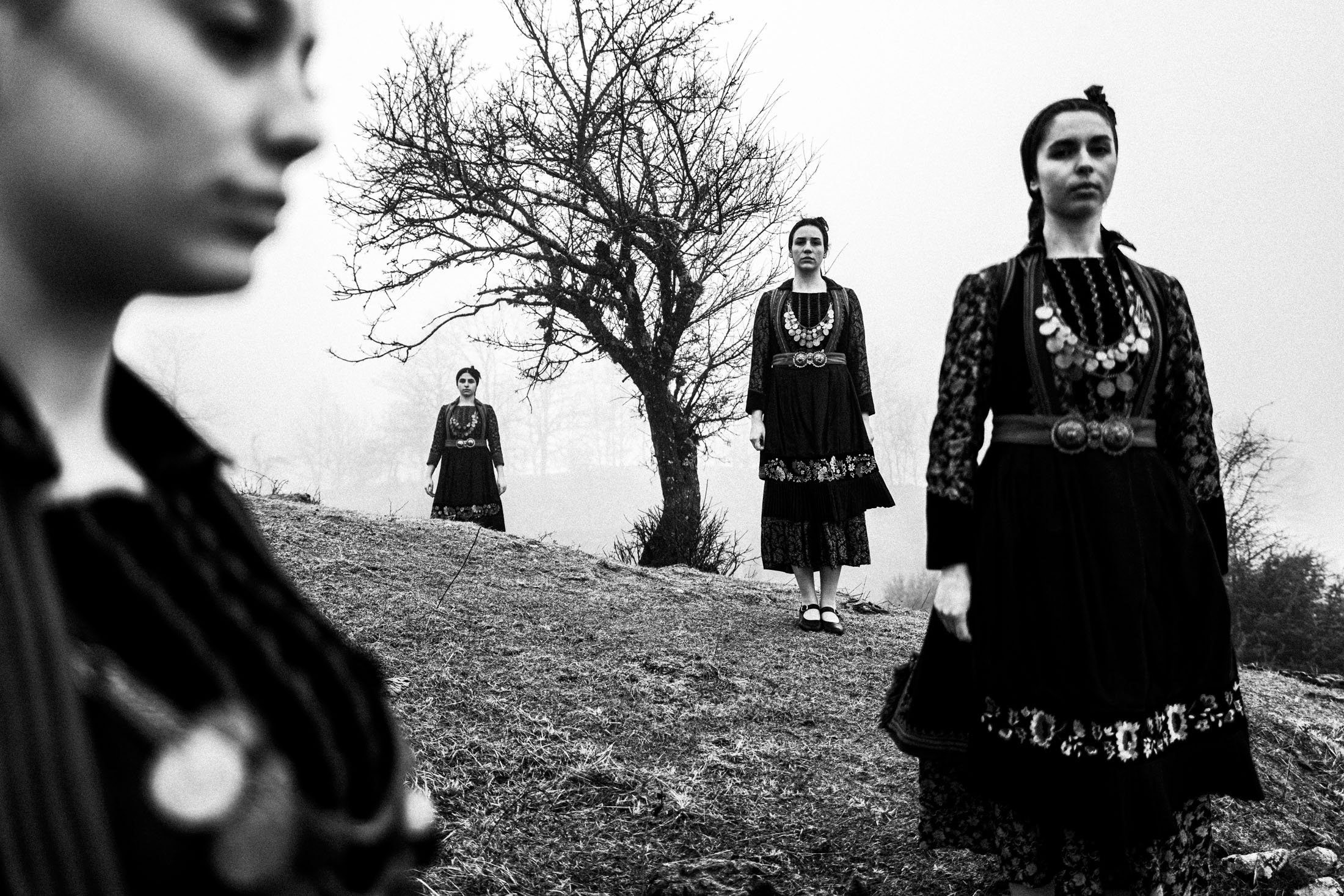 Women wearing the local costumes of Kerasovo, aka Agia Paraskevi, in Epirus inside a local house