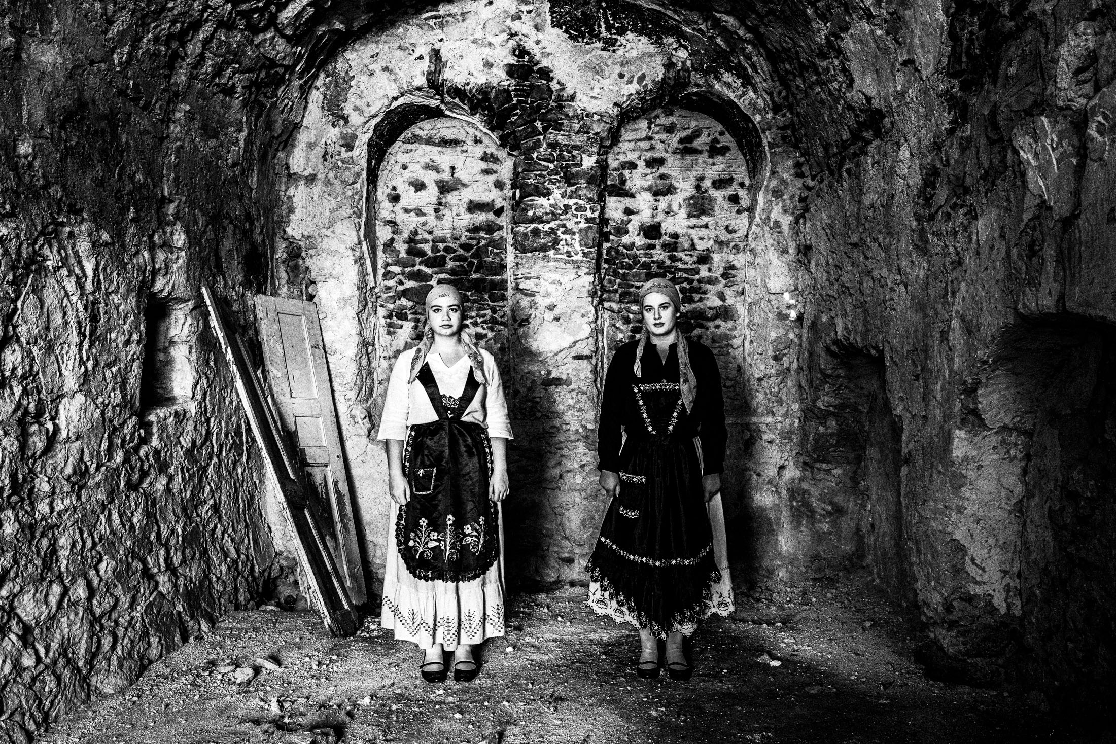 Women inside a local old stone building, wearing the costumes of Armolia, Chios