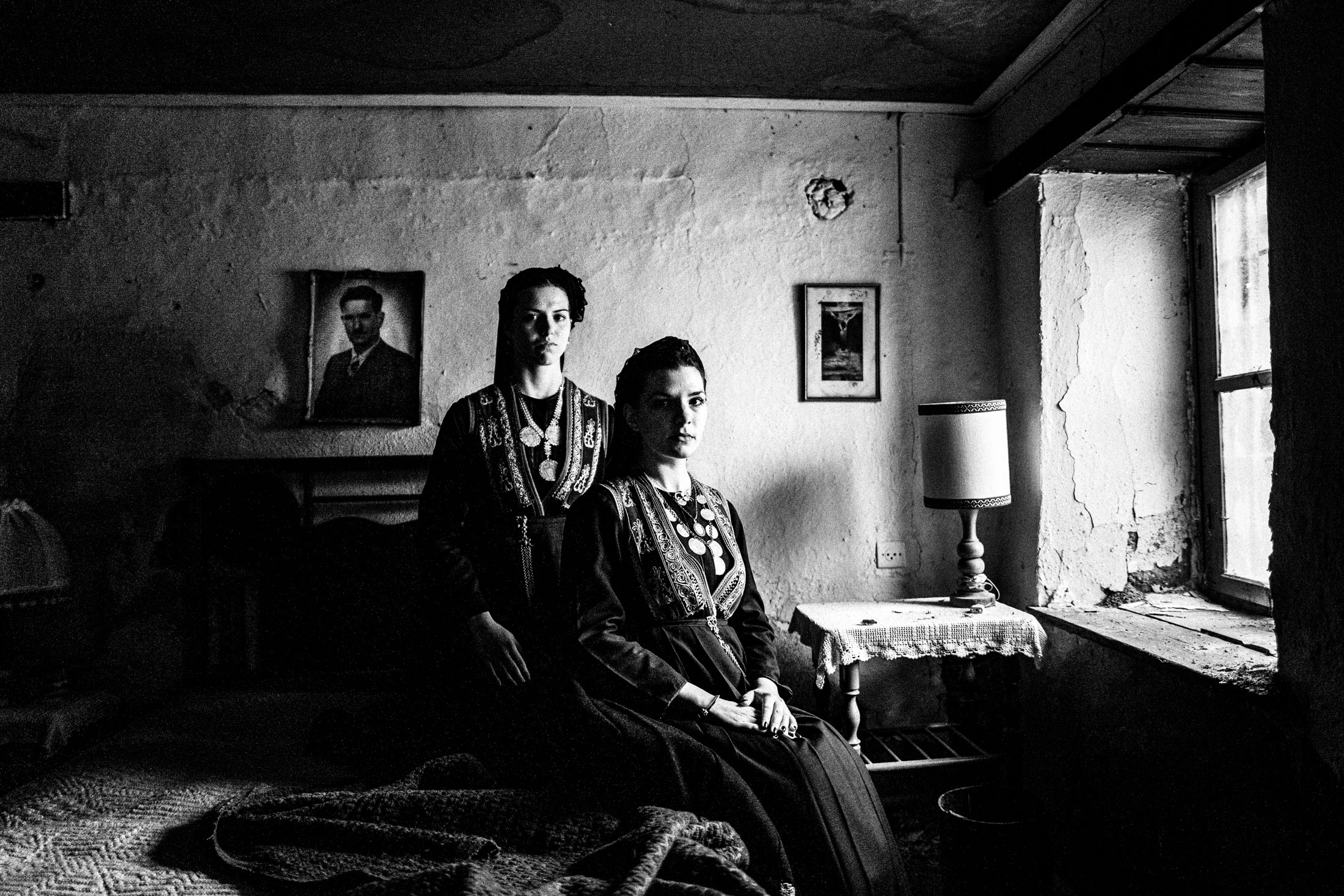 Women wearing the costumes of the nomadic group of the vlachs, posing at Seli, Veria by the window inside a local house