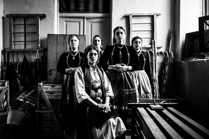 Women wearing the local costumes of Polypotamos in Florina, inside a local house