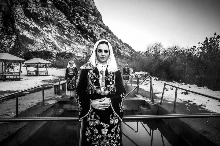 Women wearing the local costumes of Martino, Lokris, standing by the hot springs in Kammena Vourla
