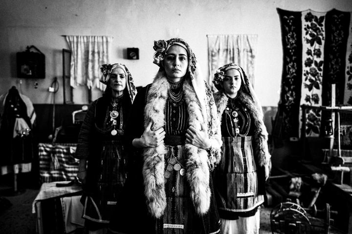 Three women wearing the local costumes of Skopos in Florina, inside a local school that also serves as a folklore museum