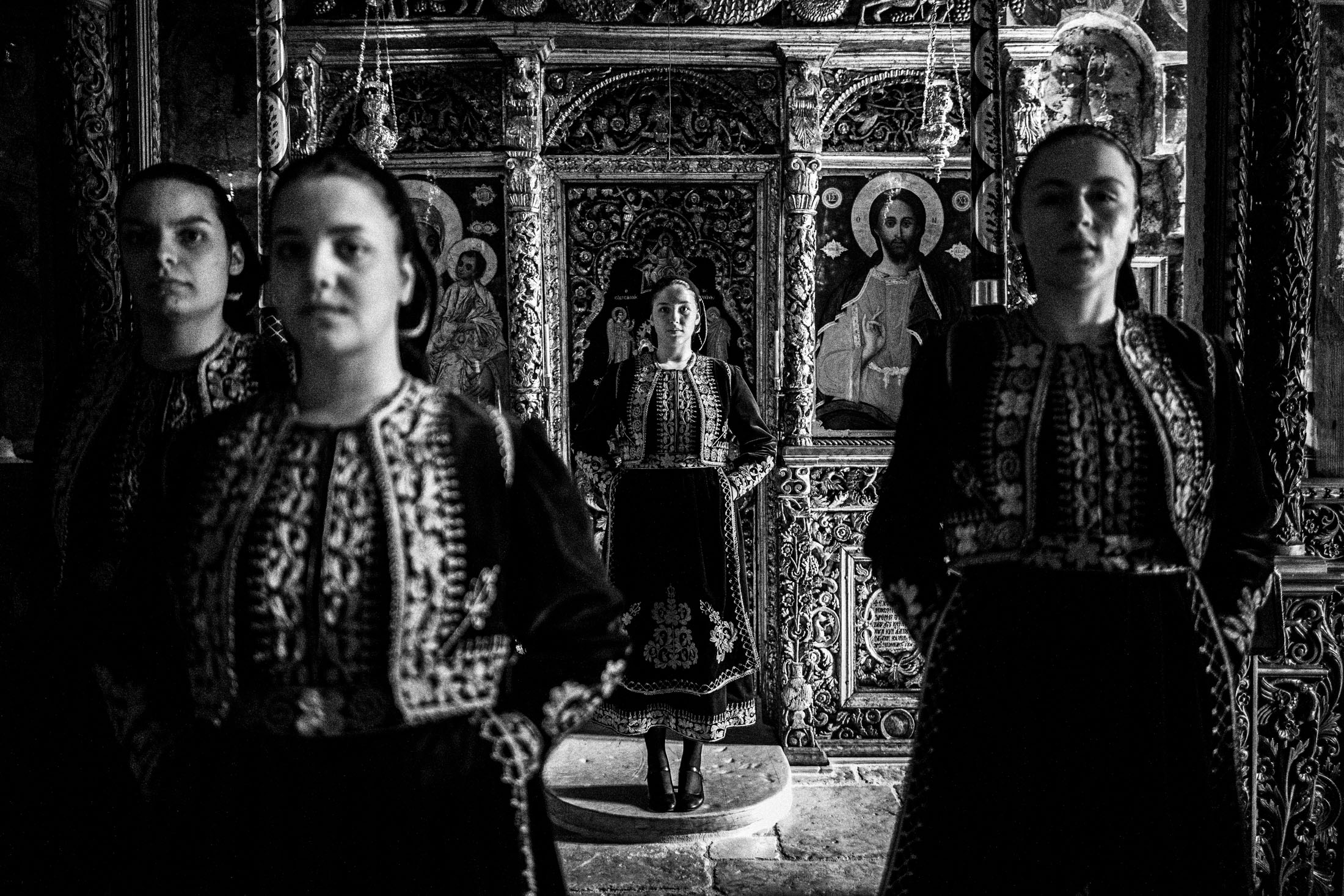 A group of women wearing the local costumes of Filiates in Thesprotia, standing inside a local orthodox church