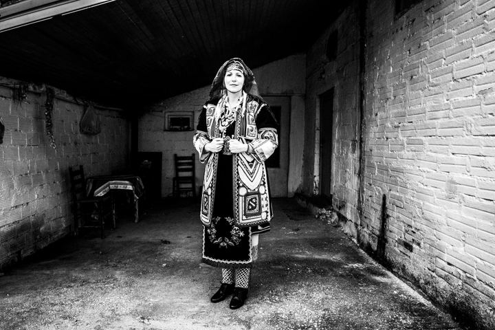 A woman weating the local costume of Isaakion in Evros, Thrace posing inside a local house