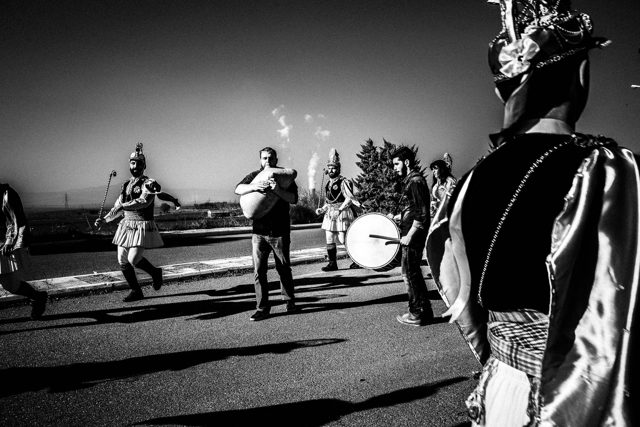 Musicians and costumed dancers beginning the Kotsamania ritual outdoors.