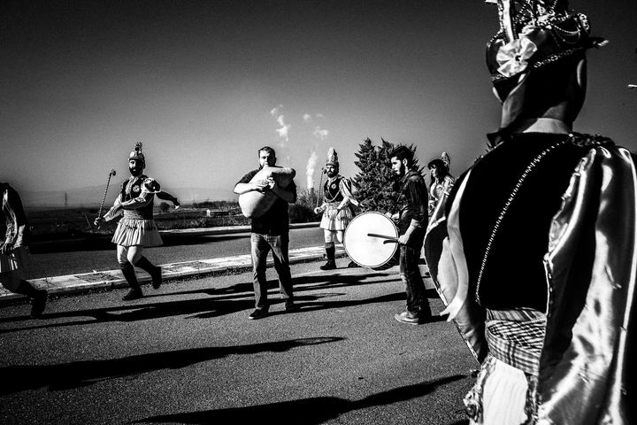 Musicians and costumed dancers beginning the Kotsamania ritual outdoors.