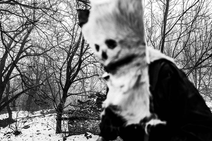 A scary bell-bearer in a snowy forest in Pagoneri, Drama.