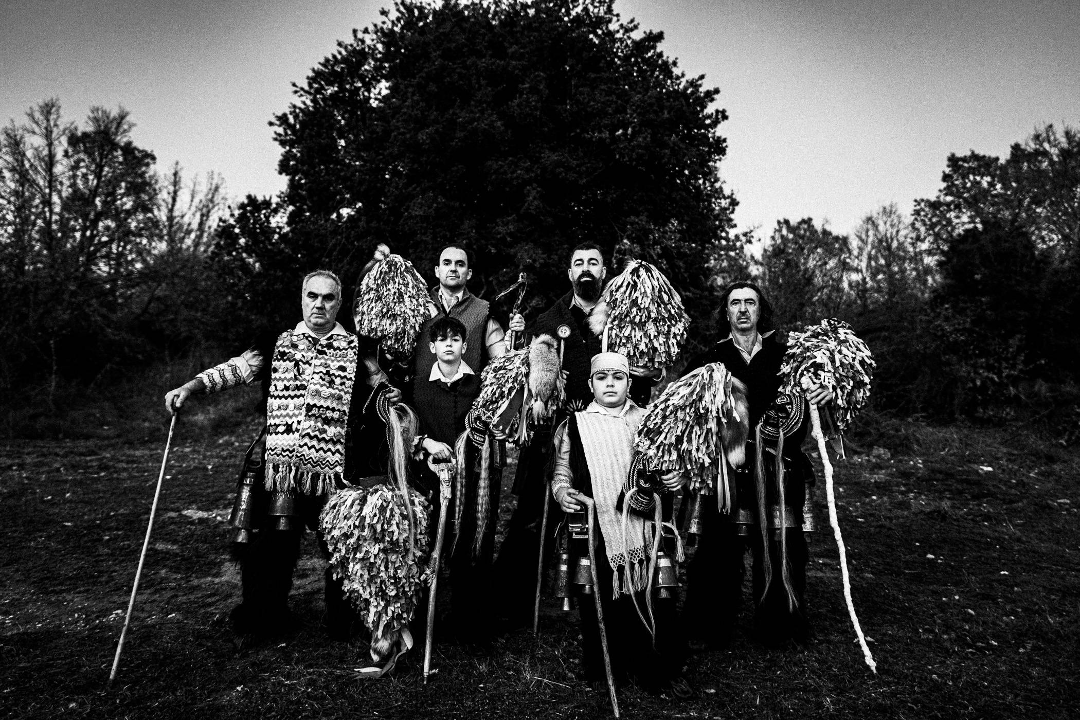 Group portrait of adult and young Koudounoforoi of Sohos in a field.