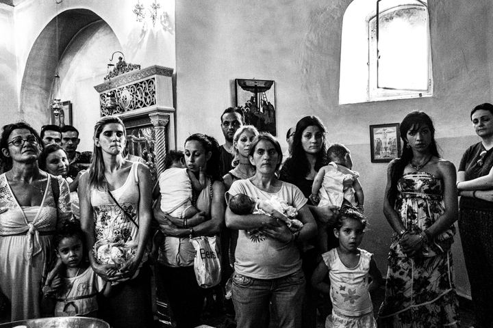 Women and children waiting inside Saint Simeon church during the summer festival.