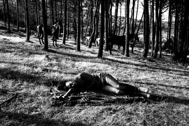 People resting in the woods around Saint Simeon after the all-night festival.