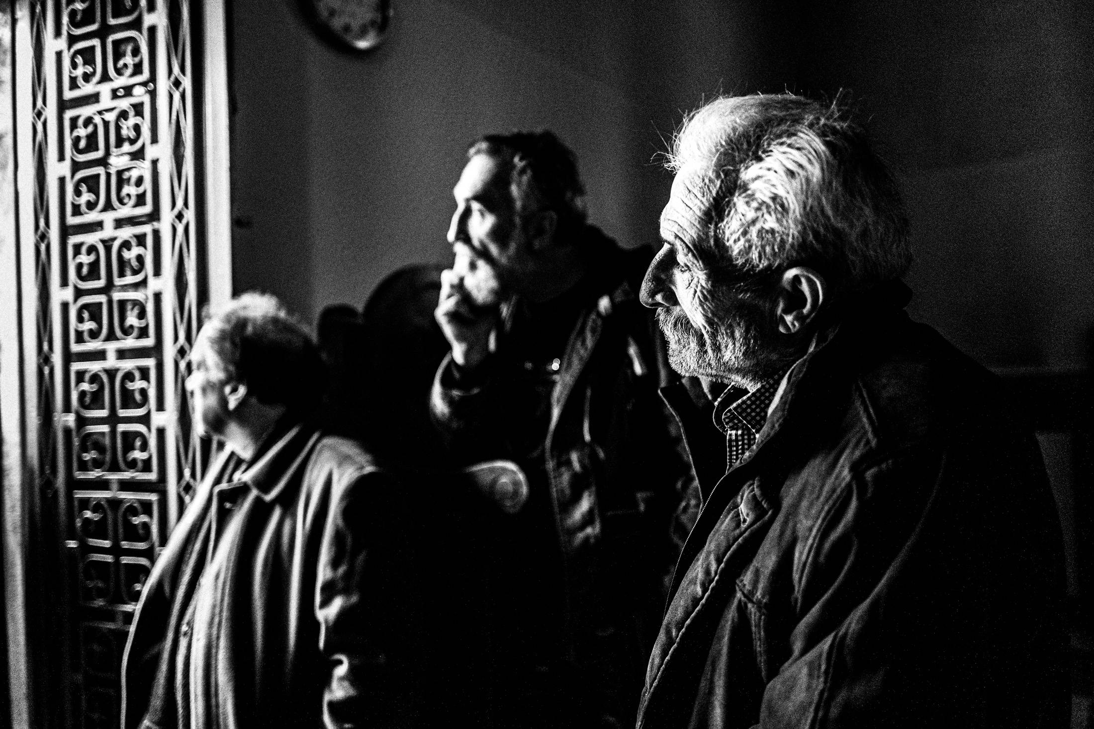 Older visitors standing inside the church at Agia Lavra.