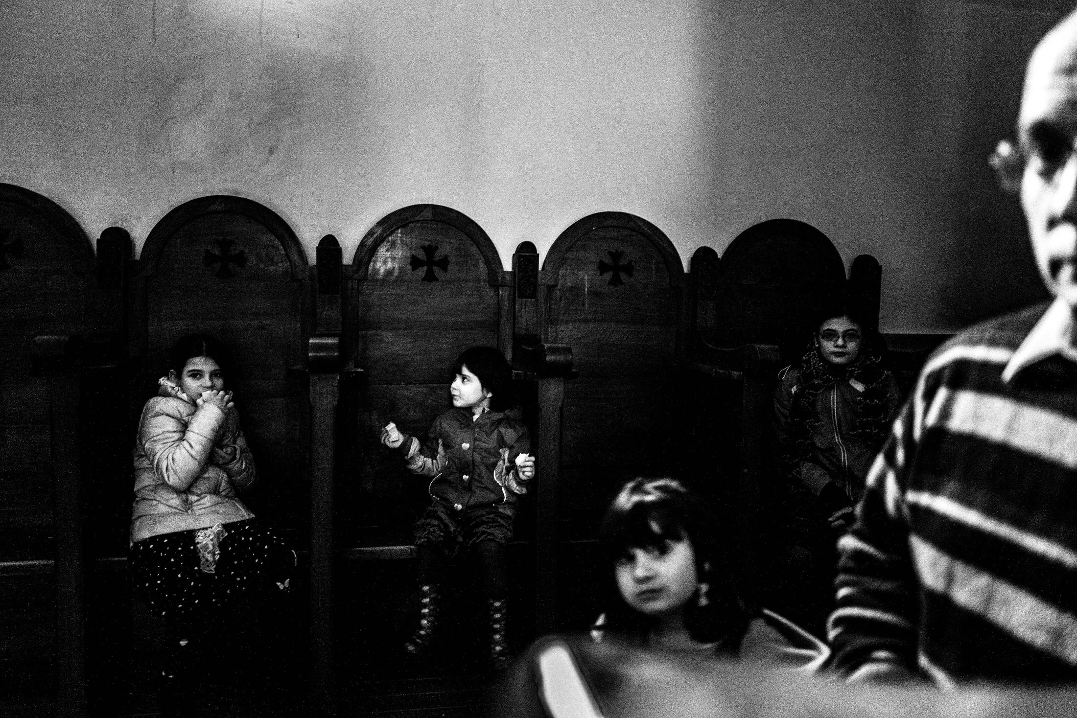 Children seated inside the church during the 25 March commemoration at Agia Lavra.